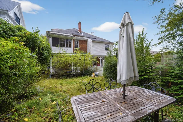 a backyard of a house with table and chairs