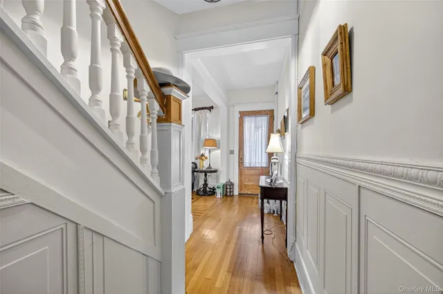 a view of a hallway with wooden floor and staircase
