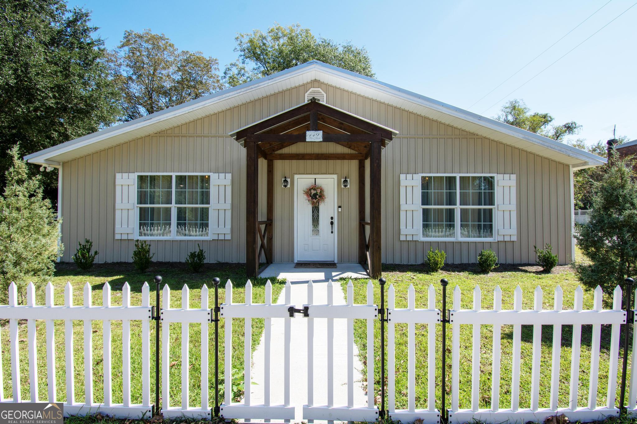 a front view of a house with a garden