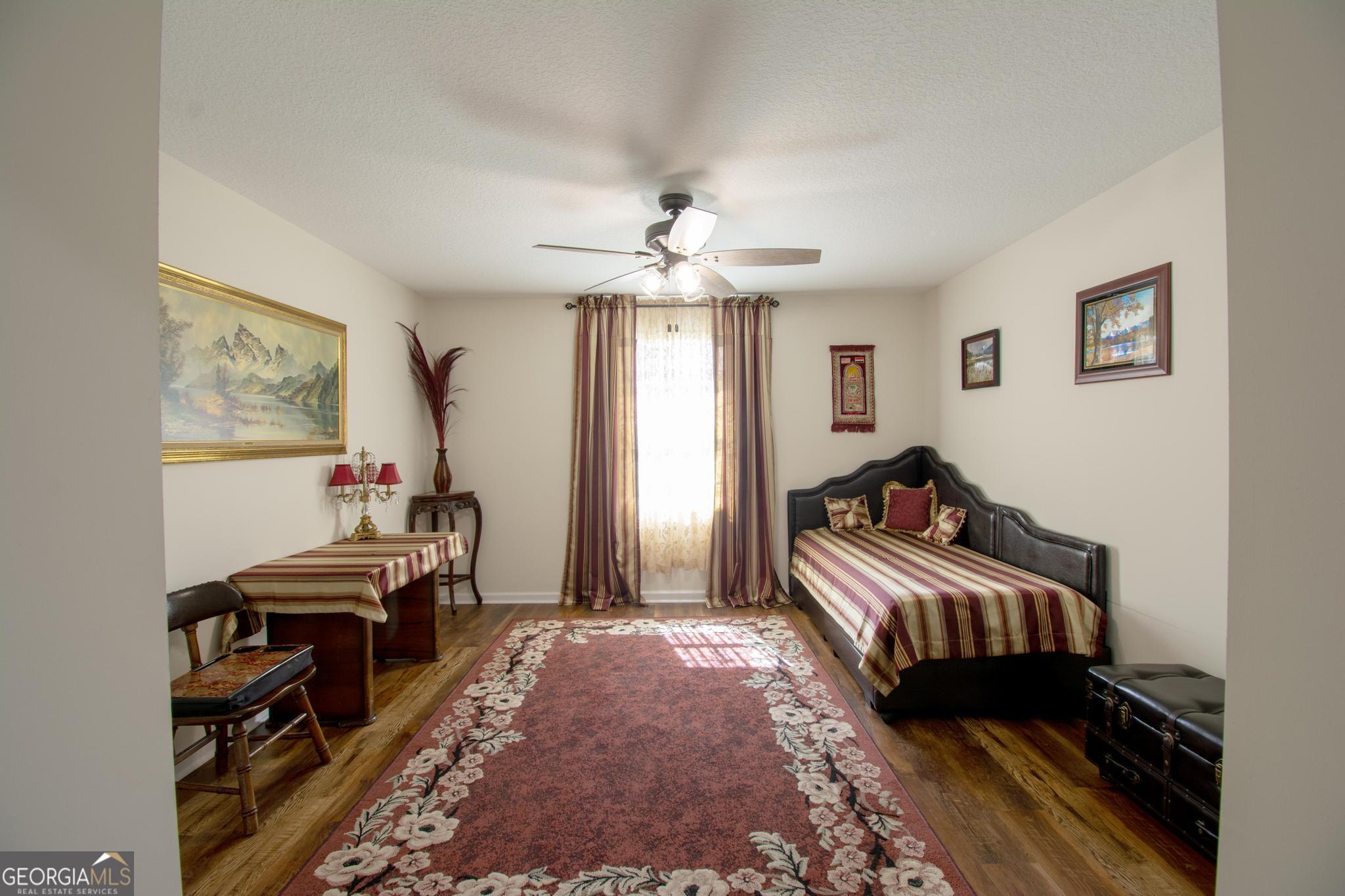 149 Main Street Rocky Ford, GA 30455 - Photo 11 of 44 a bedroom with furniture and a chandelier