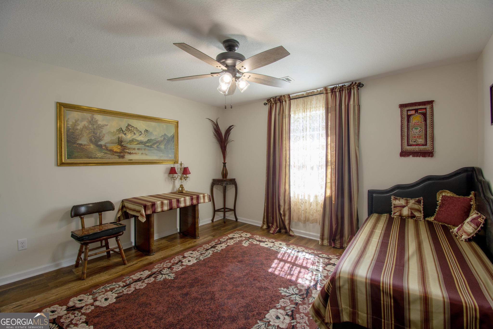 149 Main Street Rocky Ford, GA 30455 - Photo 12 of 44 a bedroom with furniture and a window