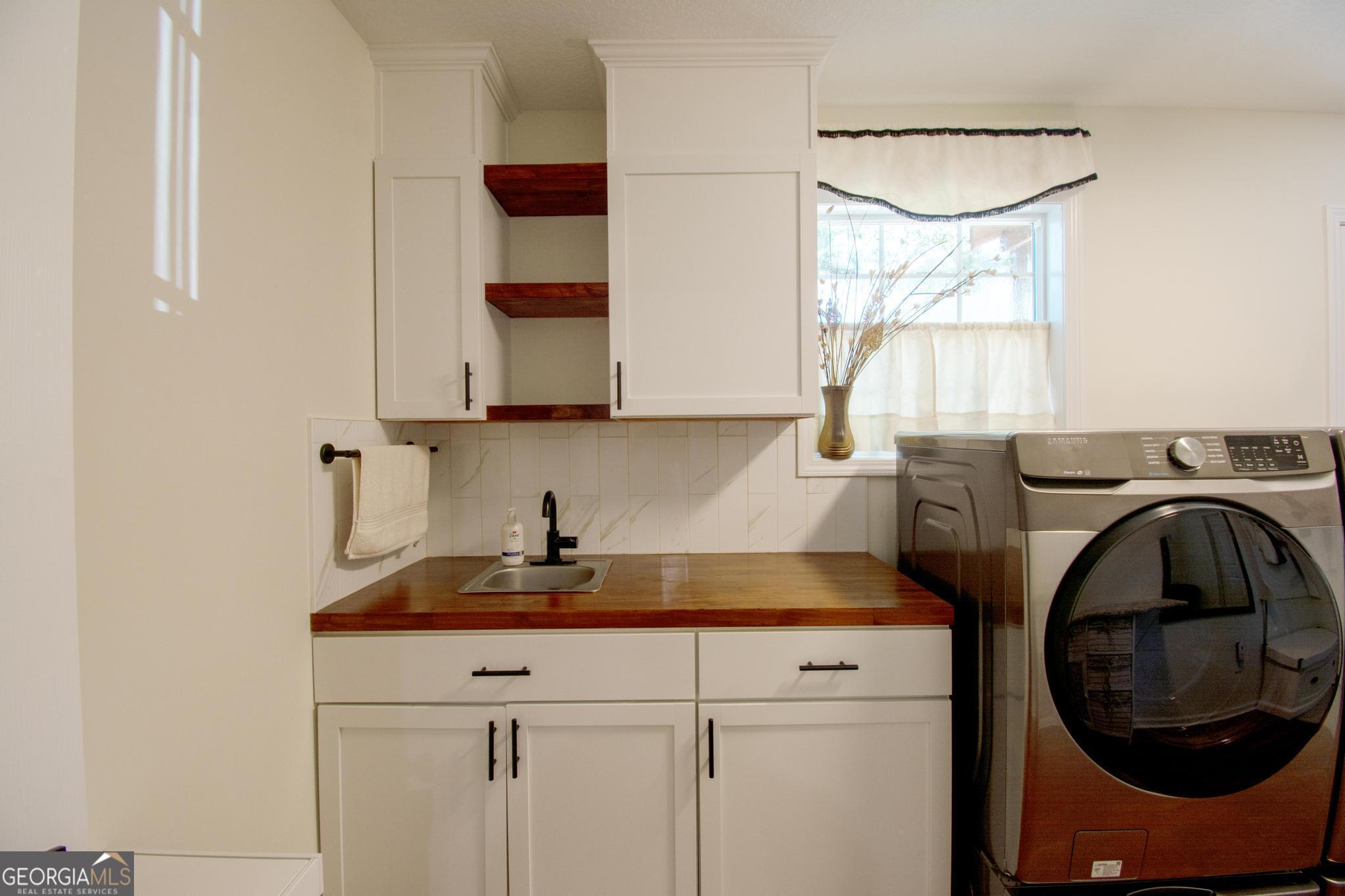 149 Main Street Rocky Ford, GA 30455 - Photo 14 of 44 a utility room with sink dryer and washer