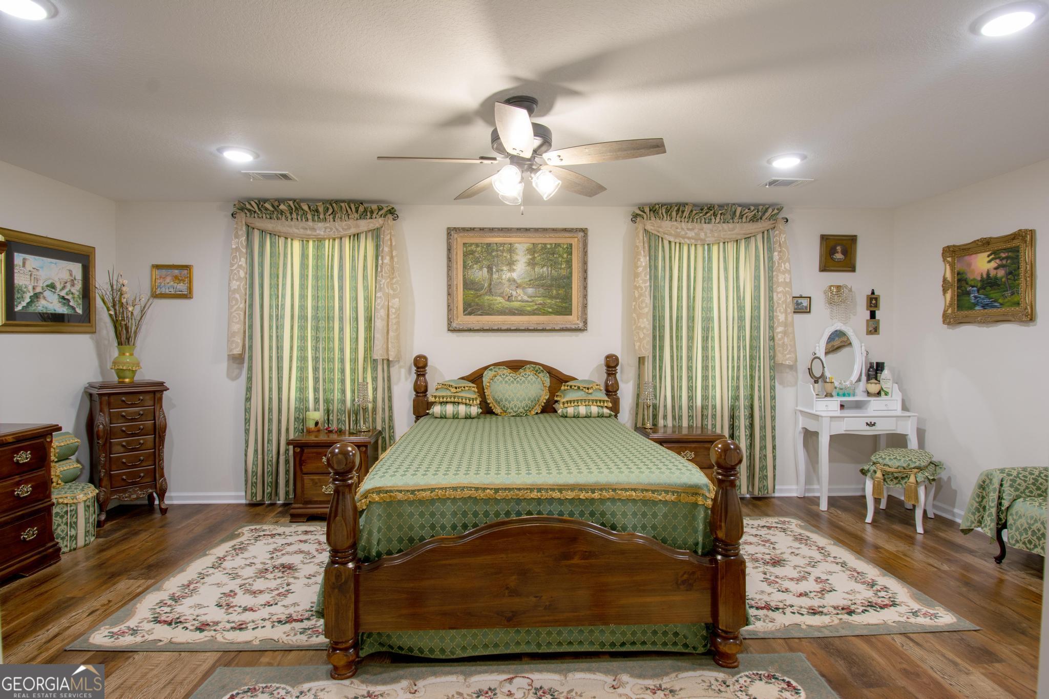 149 Main Street Rocky Ford, GA 30455 - Photo 19 of 44 a bedroom with a bed and wooden floor