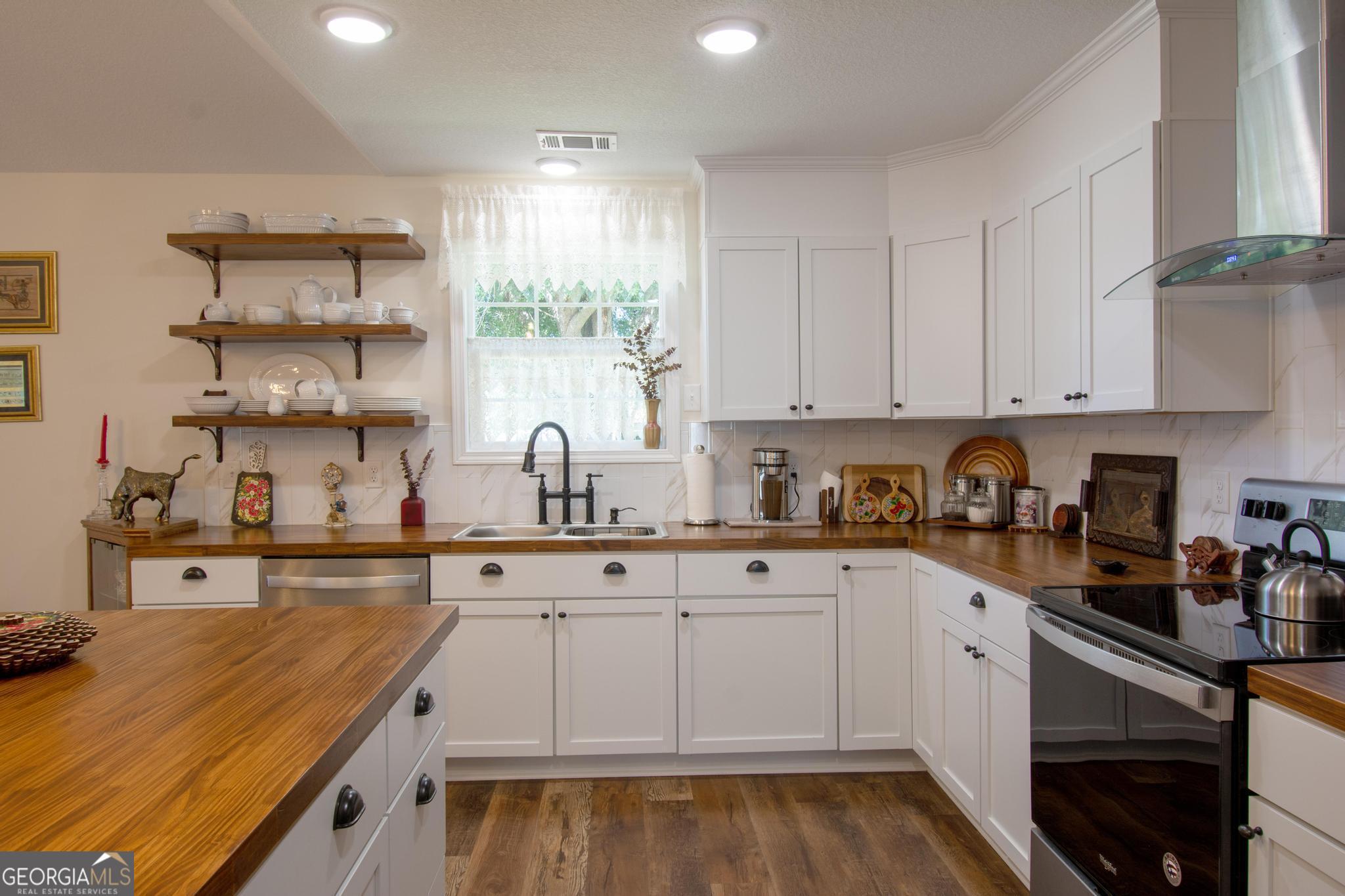 149 Main Street Rocky Ford, GA 30455 - Photo 20 of 44 a kitchen with stainless steel appliances granite countertop a sink and cabinets
