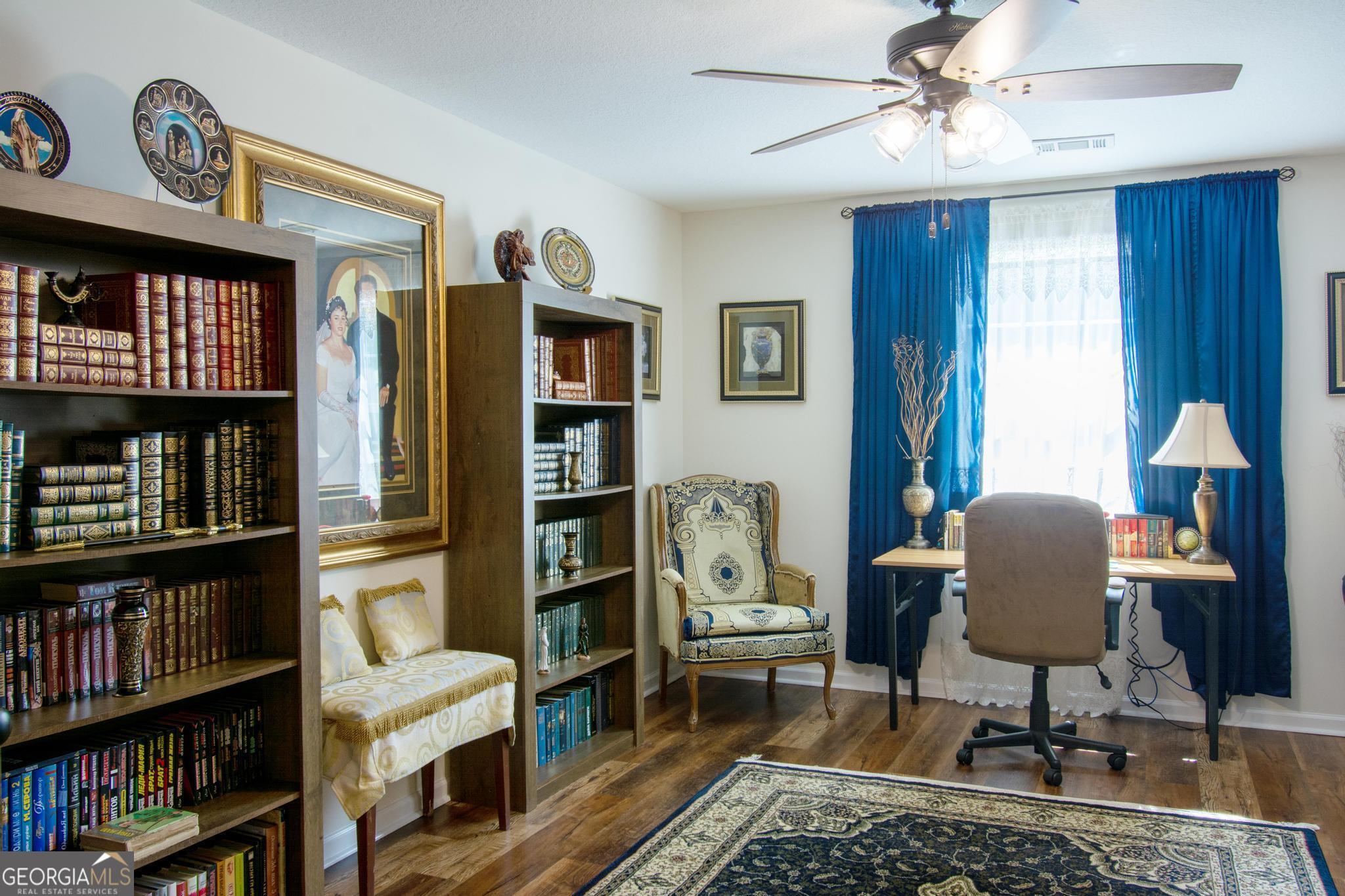 149 Main Street Rocky Ford, GA 30455 - Photo 27 of 44 a living room with furniture a book shelf and a window