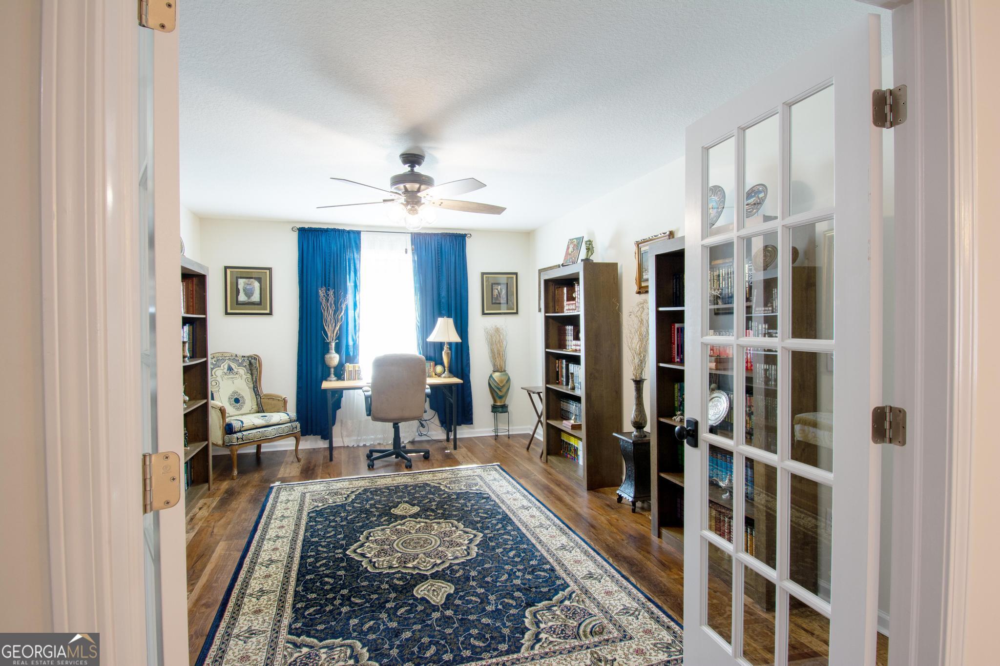 149 Main Street Rocky Ford, GA 30455 - Photo 28 of 44 a living room with furniture a rug and a chandelier