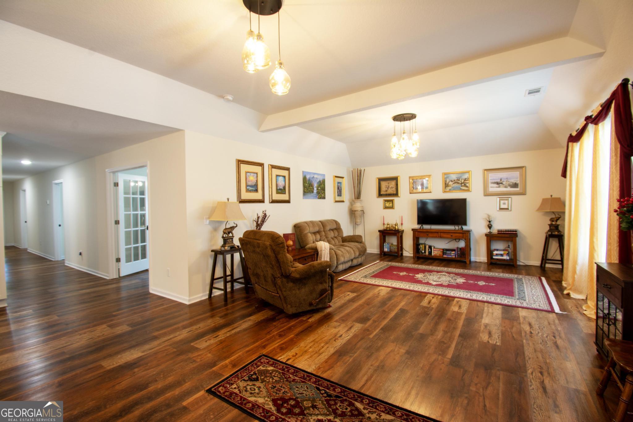 149 Main Street Rocky Ford, GA 30455 - Photo 3 of 44 a living room with furniture a flat screen tv and a table