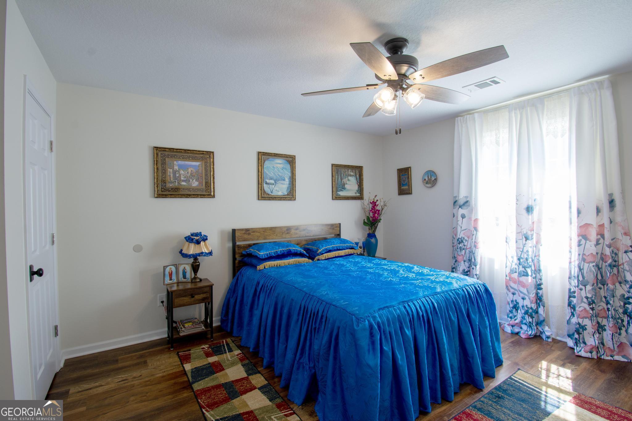 149 Main Street Rocky Ford, GA 30455 - Photo 35 of 44 a bed room with a bed and a chandelier