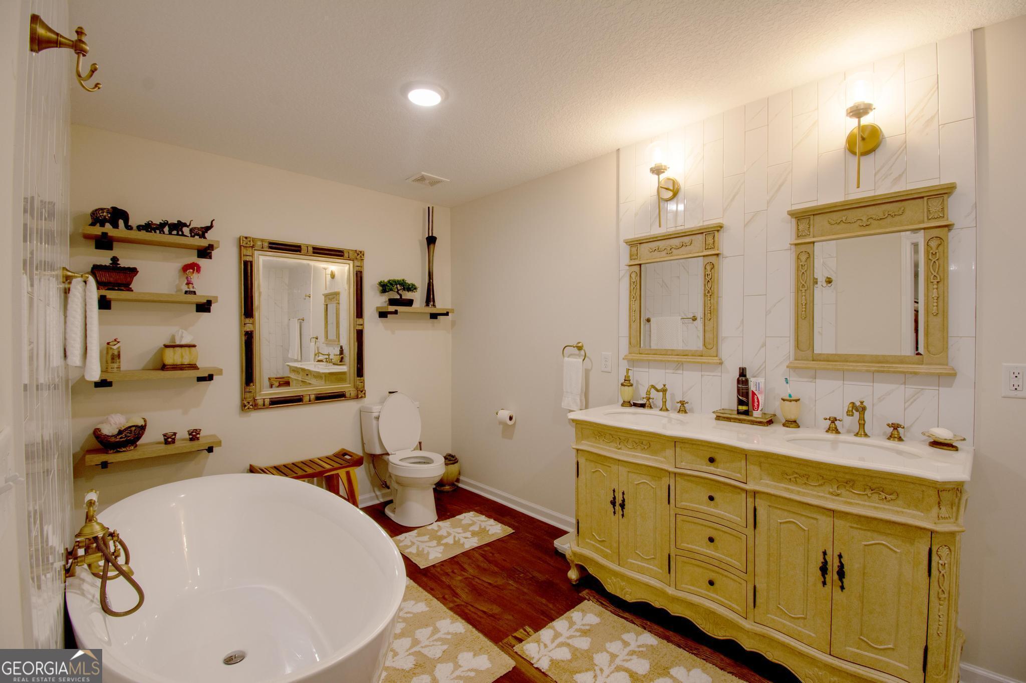 149 Main Street Rocky Ford, GA 30455 - Photo 36 of 44 a bathroom with a double vanity sink and a mirror