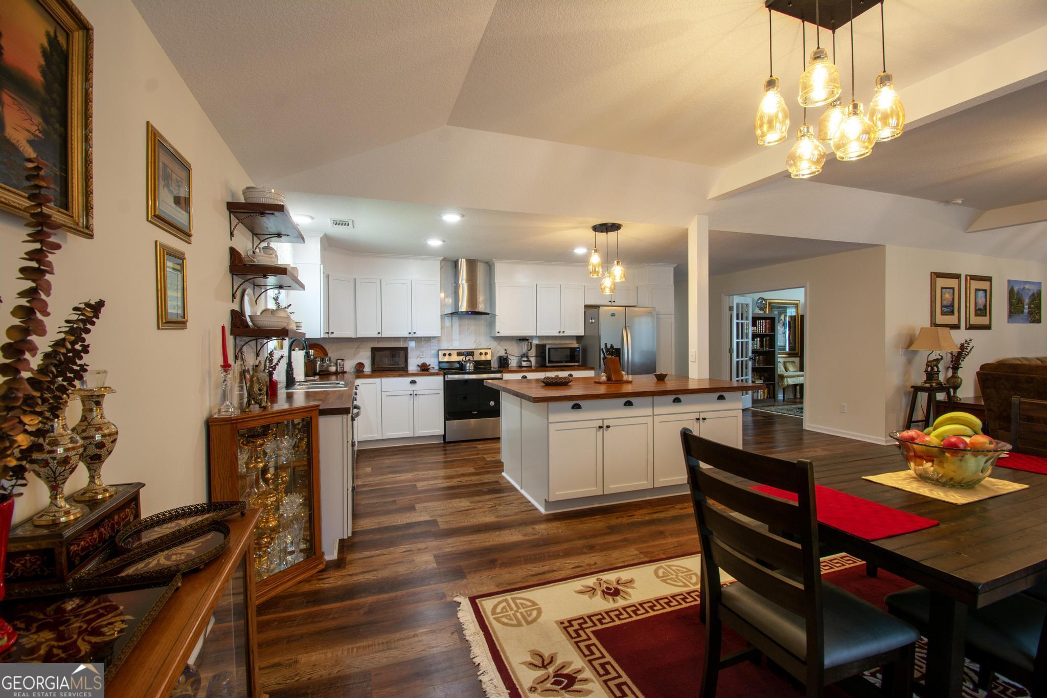 149 Main Street Rocky Ford, GA 30455 - Photo 4 of 44 a kitchen with a dining table chairs stainless steel appliances and cabinets