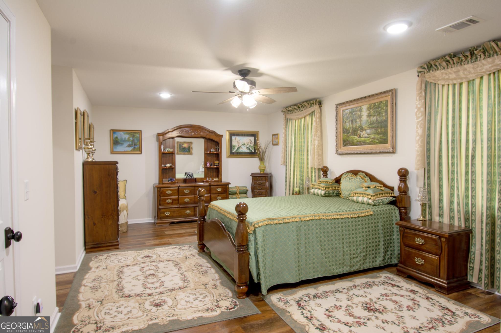 149 Main Street Rocky Ford, GA 30455 - Photo 41 of 44 a bedroom with a large bed and a dresser