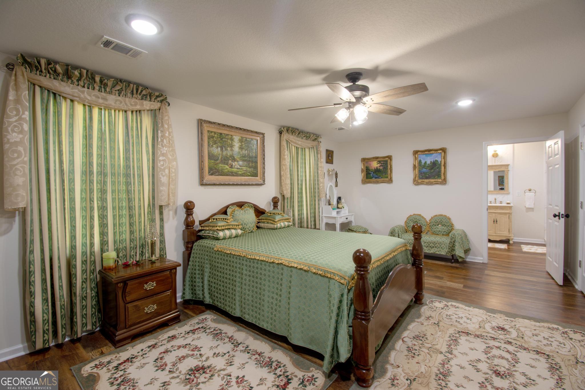 149 Main Street Rocky Ford, GA 30455 - Photo 42 of 44 a bedroom with a bed and a chandelier