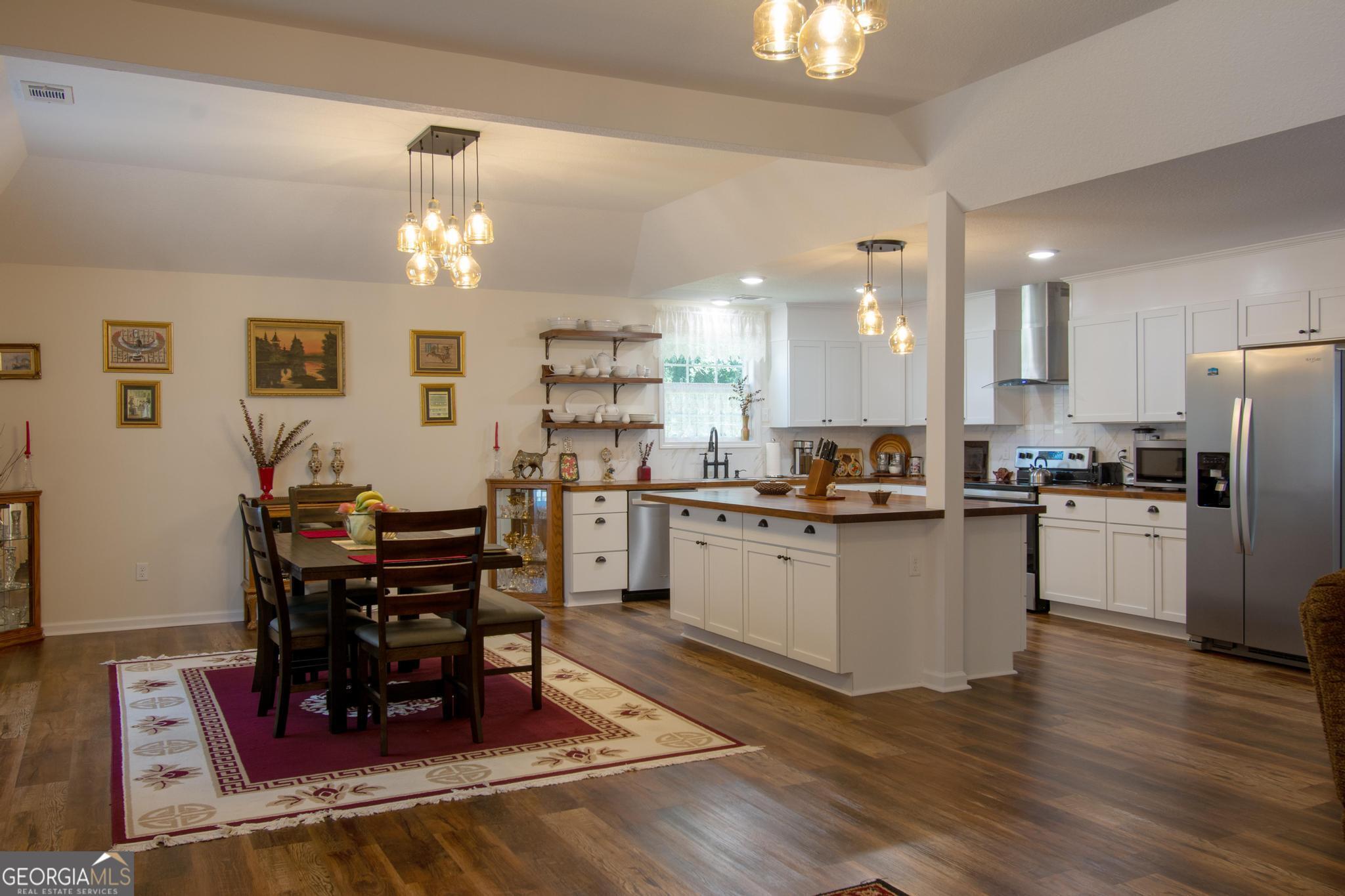 149 Main Street Rocky Ford, GA 30455 - Photo 6 of 44 a kitchen with refrigerator cabinets dining table and chairs