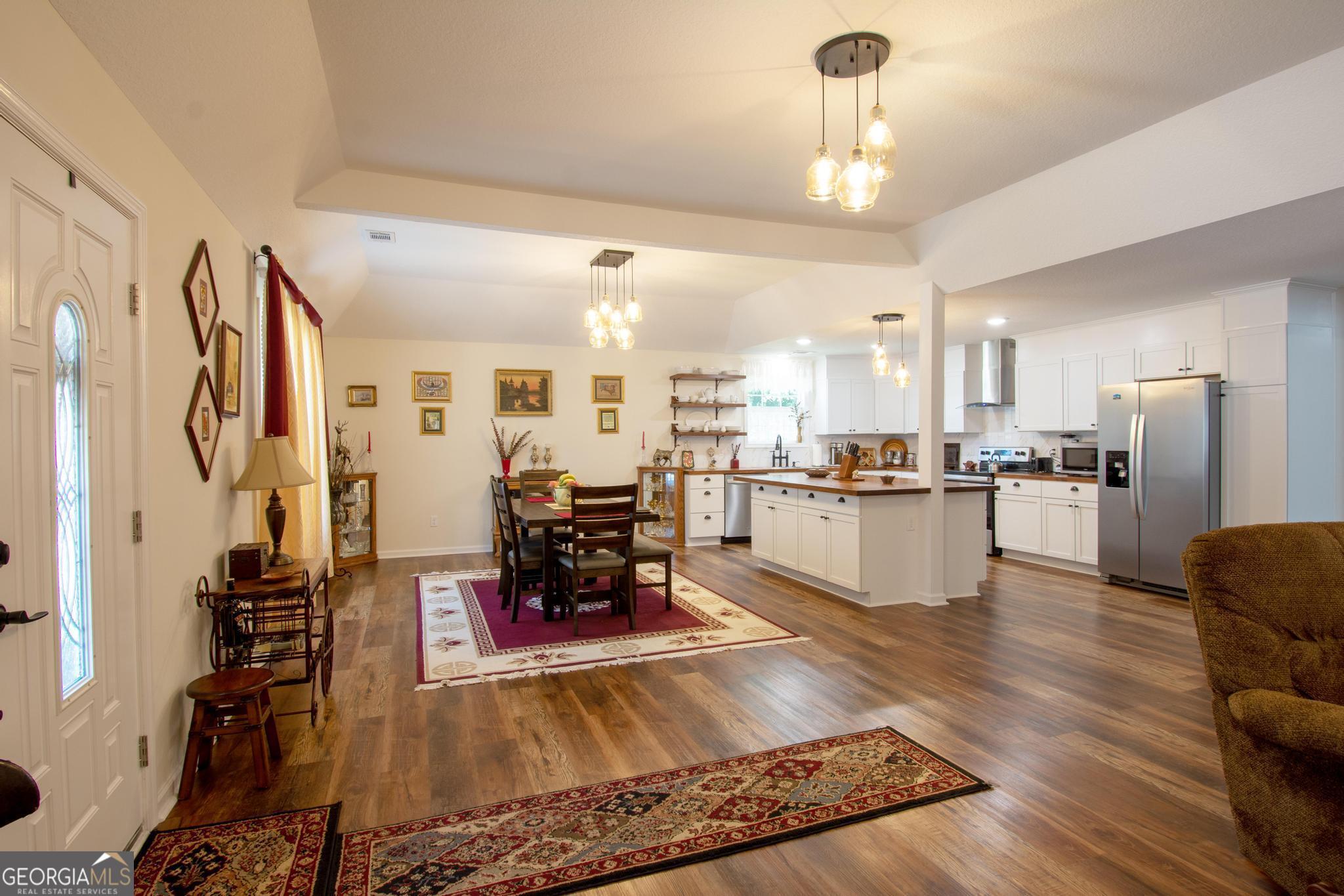 149 Main Street Rocky Ford, GA 30455 - Photo 7 of 44 a living room with stainless steel appliances kitchen island granite countertop furniture and a dining table