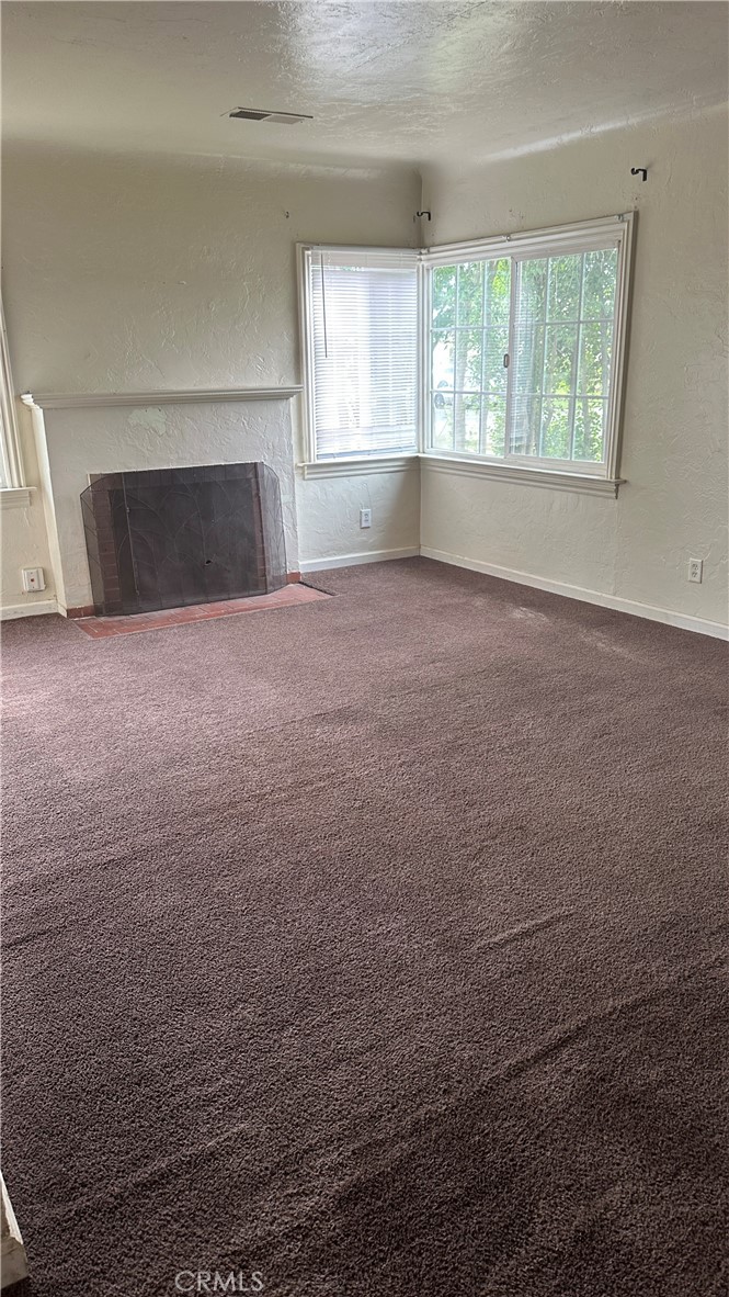 1888 Orchard Lane Merced, CA 95340 - Photo 9 of 28 an empty room with wooden floor and windows