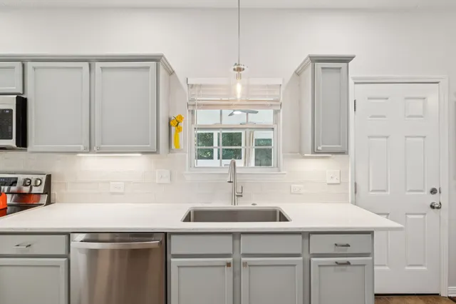a kitchen with a sink and cabinets