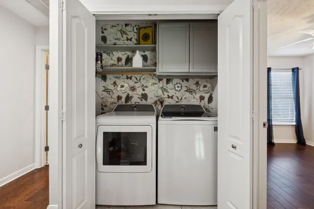 a view of a hallway with wooden floor and closet
