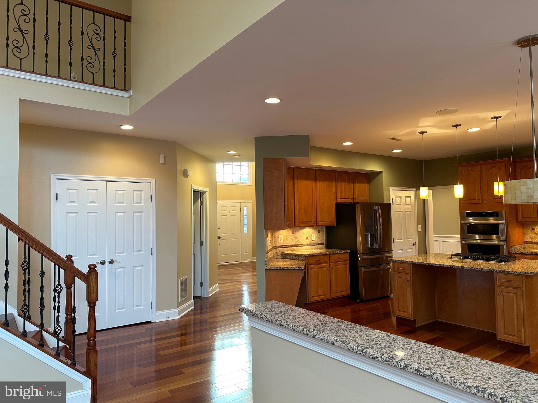 3215 Spring Rain Court Herndon, VA 20171 - Photo 13 of 39 a kitchen with stainless steel appliances kitchen island granite countertop a refrigerator and stove