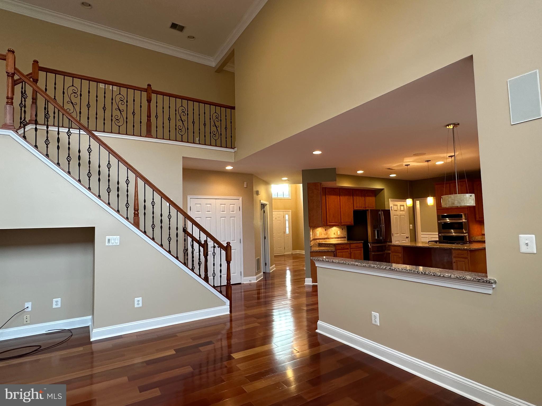 3215 Spring Rain Court Herndon, VA 20171 - Photo 14 of 39 a view of a hallway with wooden floor and a kitchen