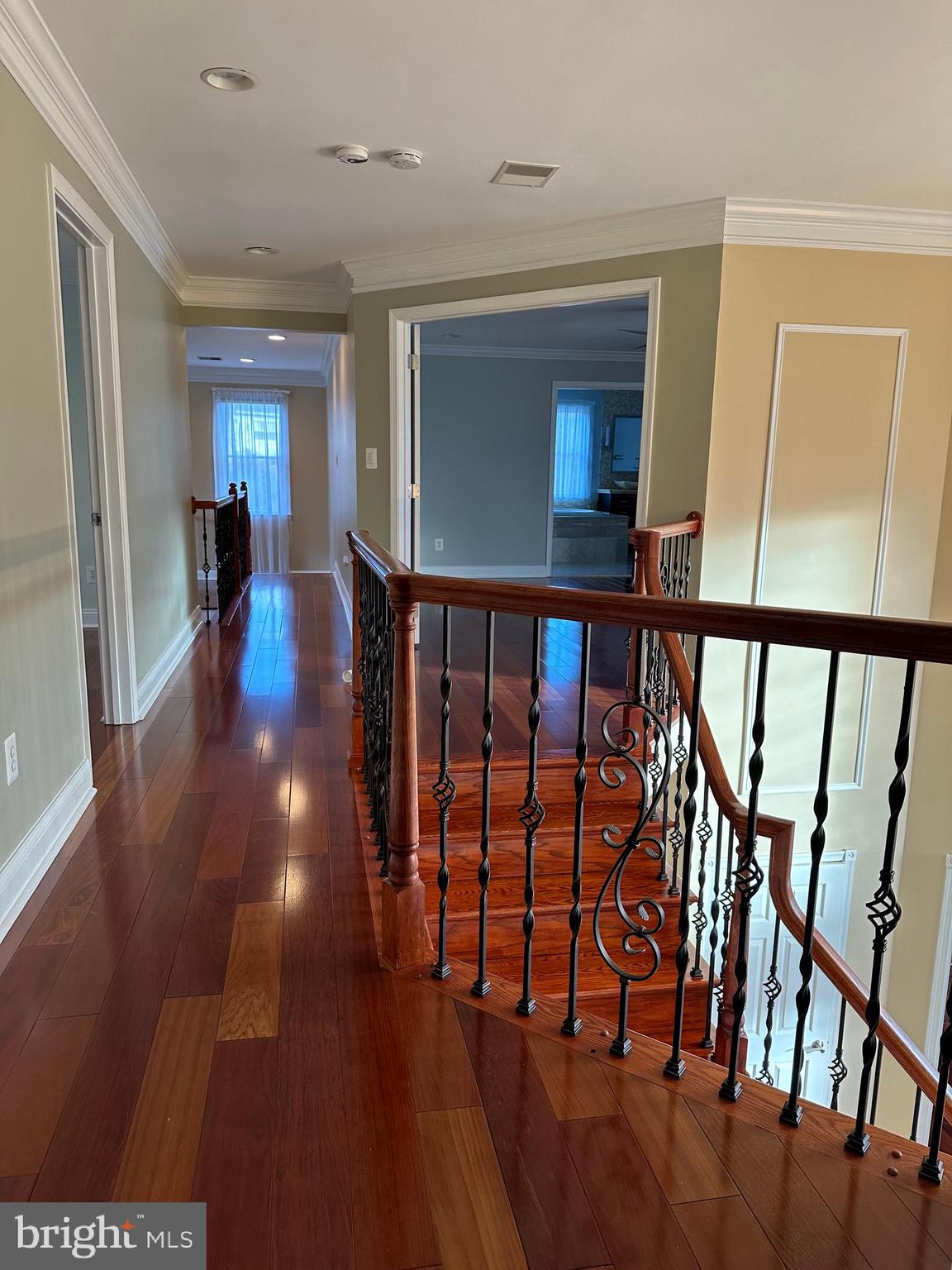 3215 Spring Rain Court Herndon, VA 20171 - Photo 17 of 39 a view of a hallway with wooden floor and stairs