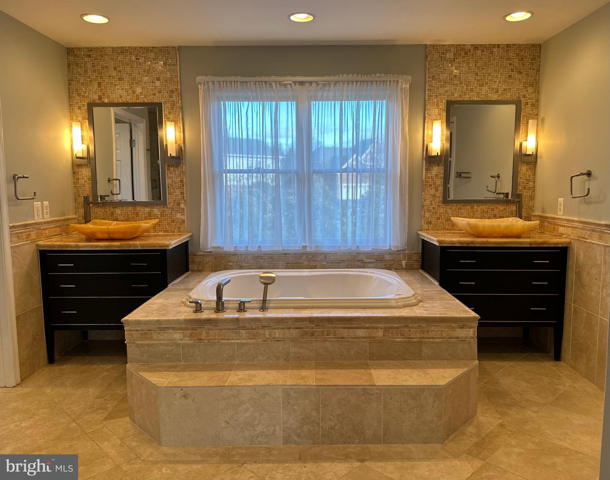 3215 Spring Rain Court Herndon, VA 20171 - Photo 22 of 39 a bathroom with a tub a sink and mirror