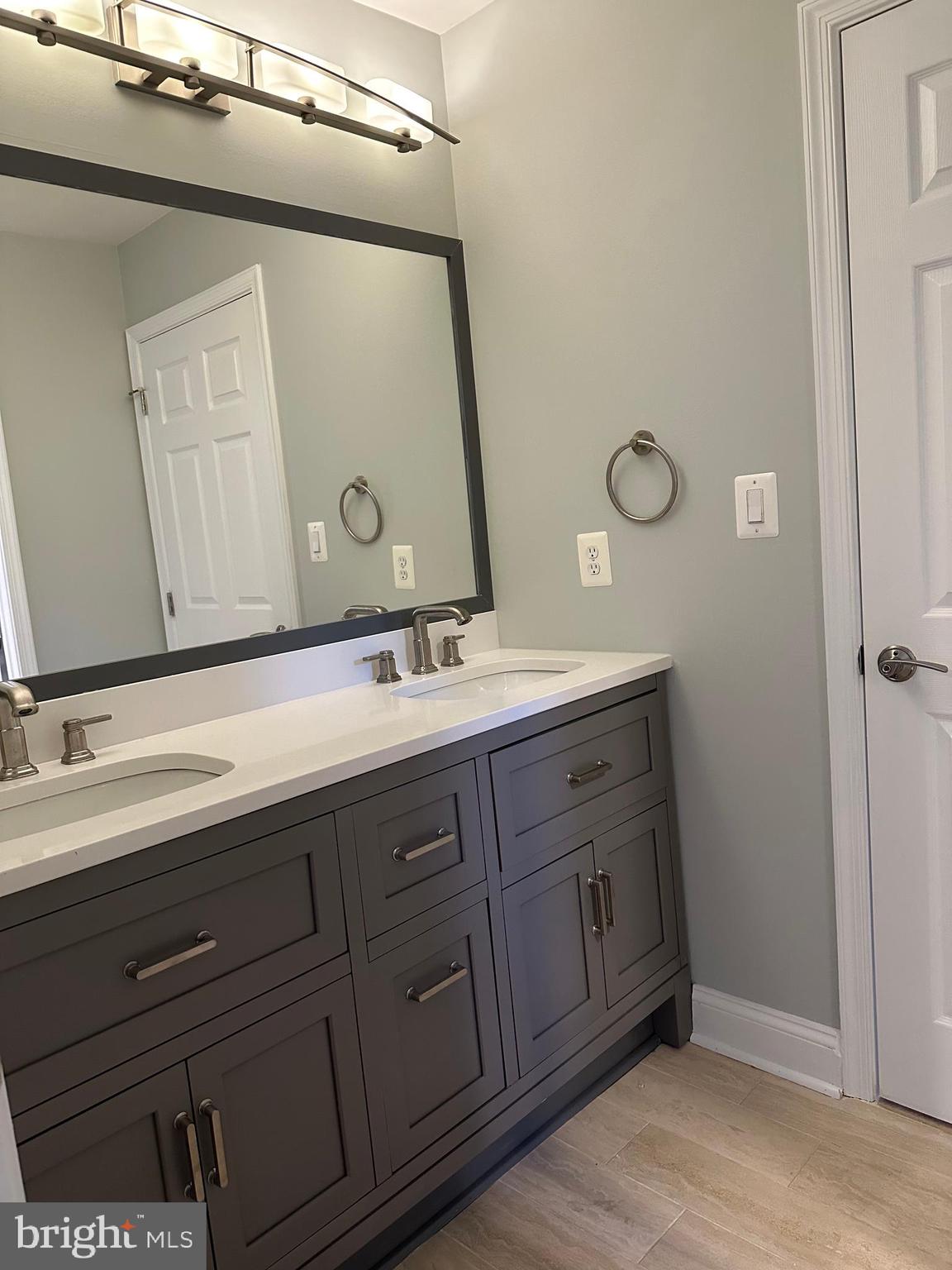 3215 Spring Rain Court Herndon, VA 20171 - Photo 26 of 39 a bathroom with a double vanity sink and a mirror