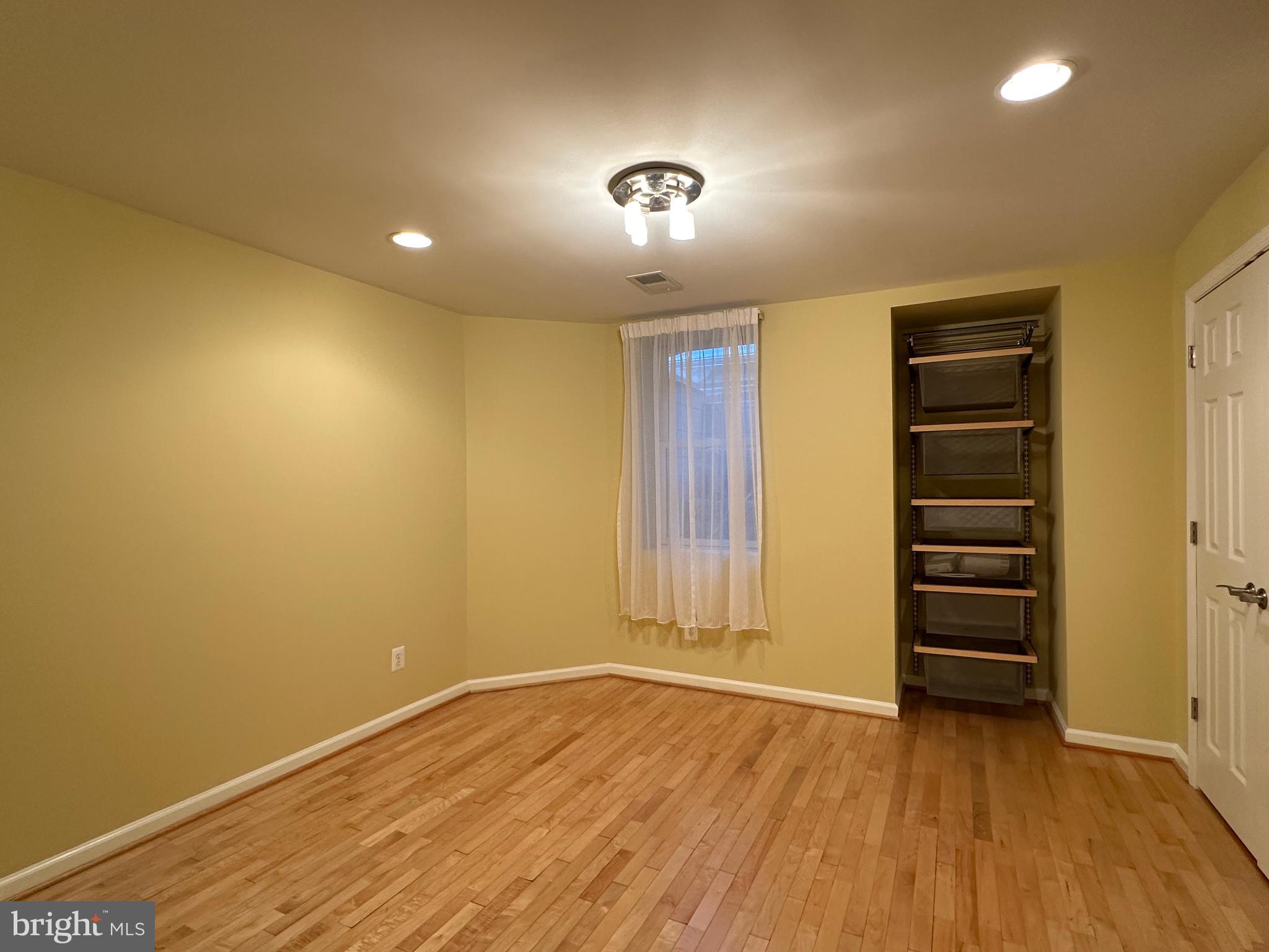 3215 Spring Rain Court Herndon, VA 20171 - Photo 36 of 39 wooden floor in an empty room with a window