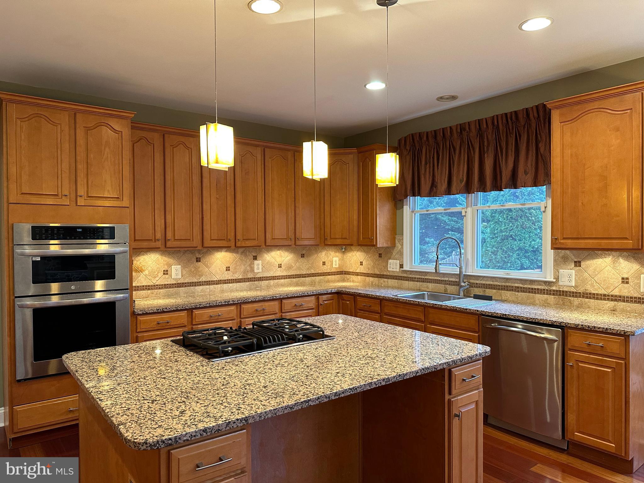 3215 Spring Rain Court Herndon, VA 20171 - Photo 9 of 39 a kitchen with a sink a stove a counter space and a window