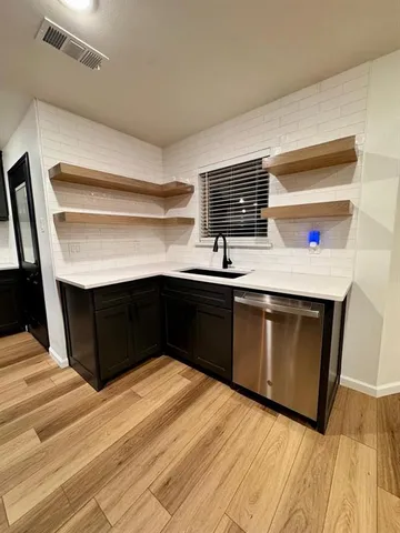 a kitchen with a sink and a stove