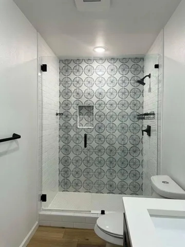 a bathroom with a sink toilet and shower