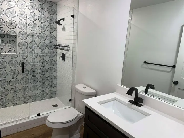 a bathroom with a toilet and a shower