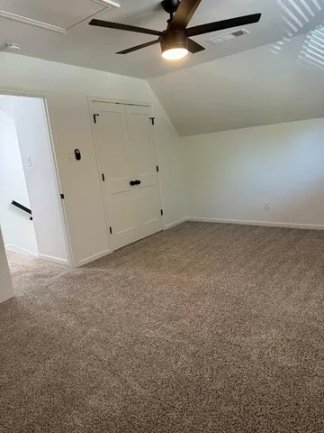 a view of room with wooden floor and closet