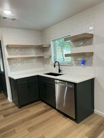 a kitchen with a sink and wooden cabinets