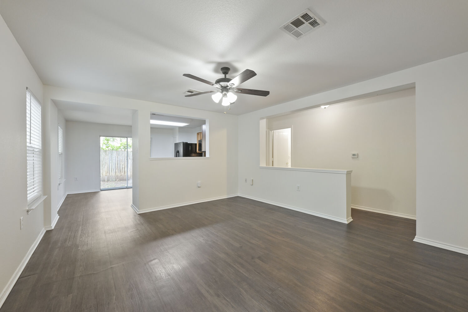 6733 Doyal Drive Austin, TX 78747 - Photo 4 of 28 A versatile interior space featuring modern flooring and ample natural illumination from multiple windows.