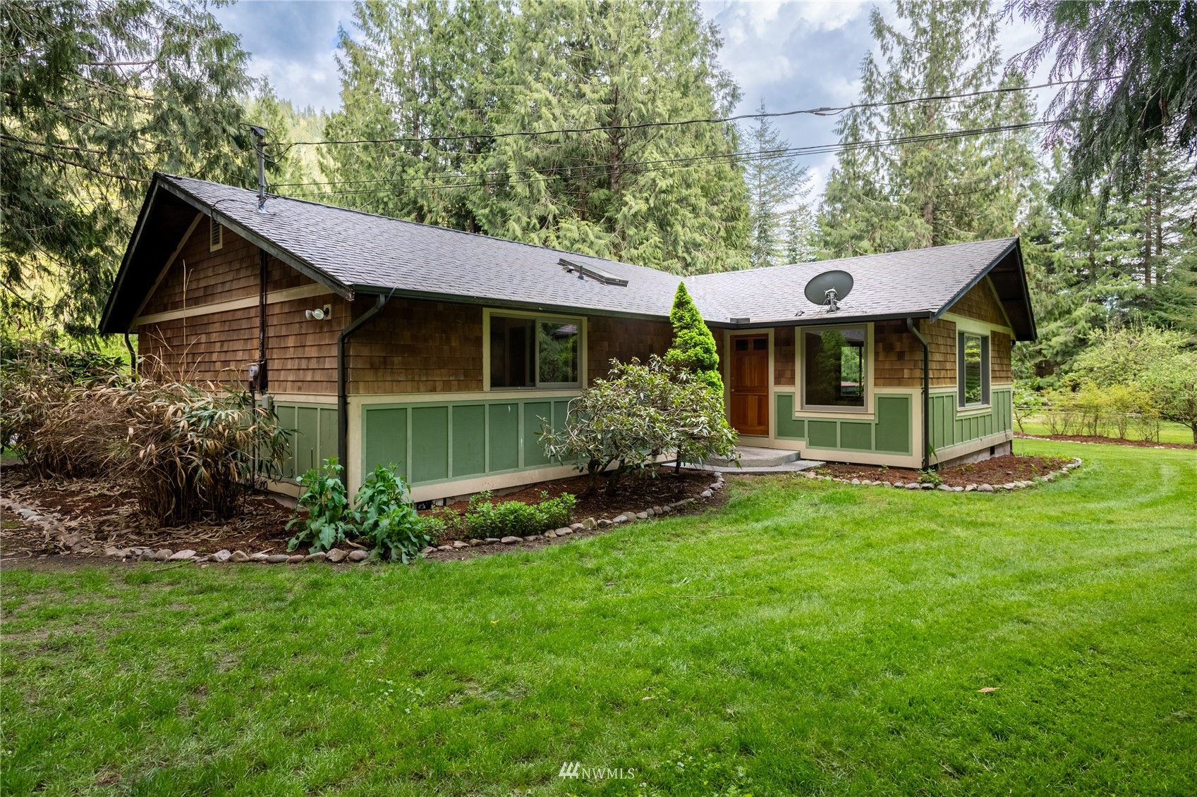 6262 North Fork Road Deming, WA 98244 - Photo 3 of 38 a view of a house with a yard plants and large tree