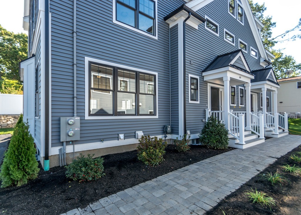 37 Riverside Street, Unit 37 Needham, MA 02494 - Photo 33 of 39 a front view of a house with garden