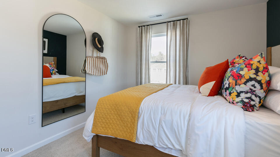 922 Sculptor Street Wendell, NC 27591 - Photo 27 of 51 a bedroom with a bed and a window