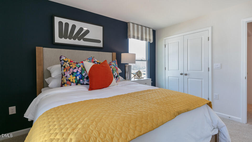 922 Sculptor Street Wendell, NC 27591 - Photo 28 of 51 a bed sitting in a bedroom next to a window