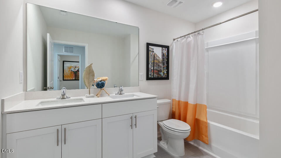 922 Sculptor Street Wendell, NC 27591 - Photo 30 of 51 a bathroom with a toilet sink vanity tub and mirror