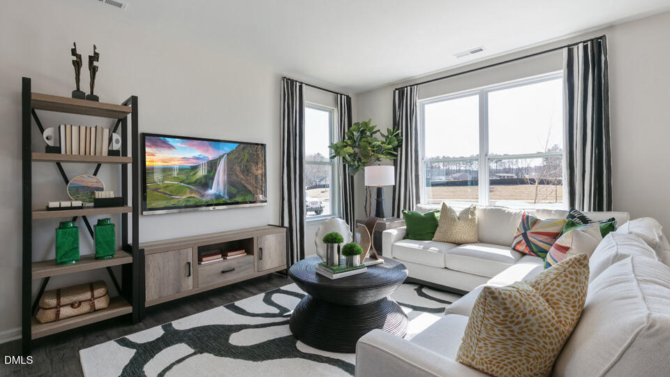 922 Sculptor Street Wendell, NC 27591 - Photo 9 of 51 a living room with furniture and a flat screen tv