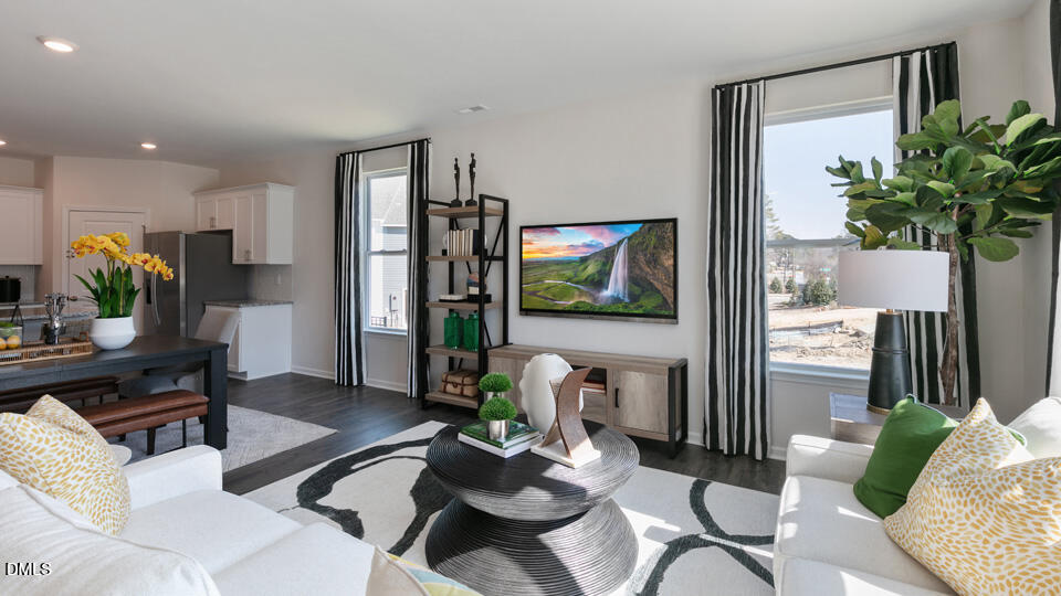 922 Sculptor Street Wendell, NC 27591 - Photo 10 of 51 a living room with furniture potted plant a window and a flat screen tv