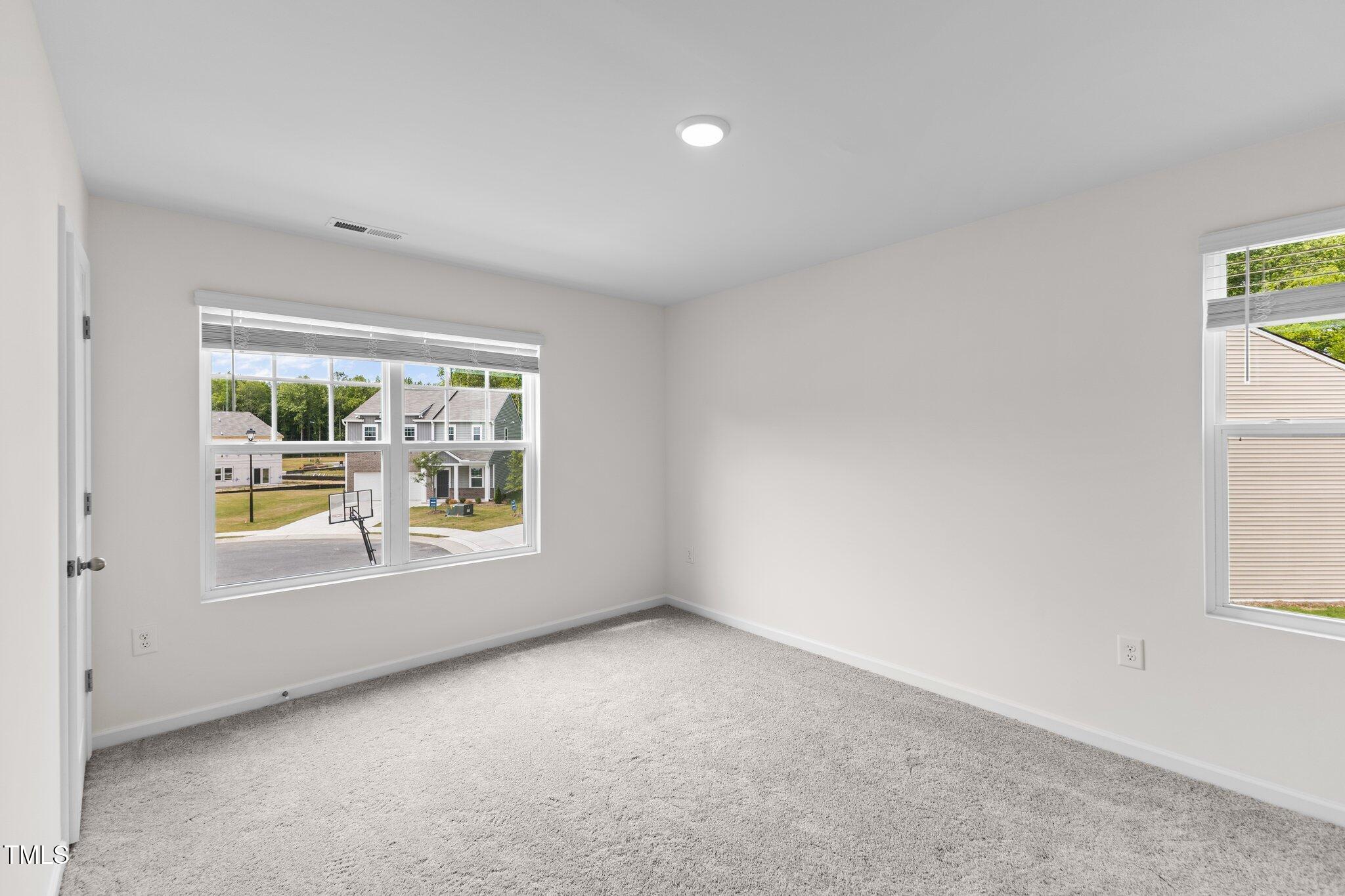 109 Gladstone Loop Clayton, NC 27520 - Photo 16 of 21 an empty room with windows