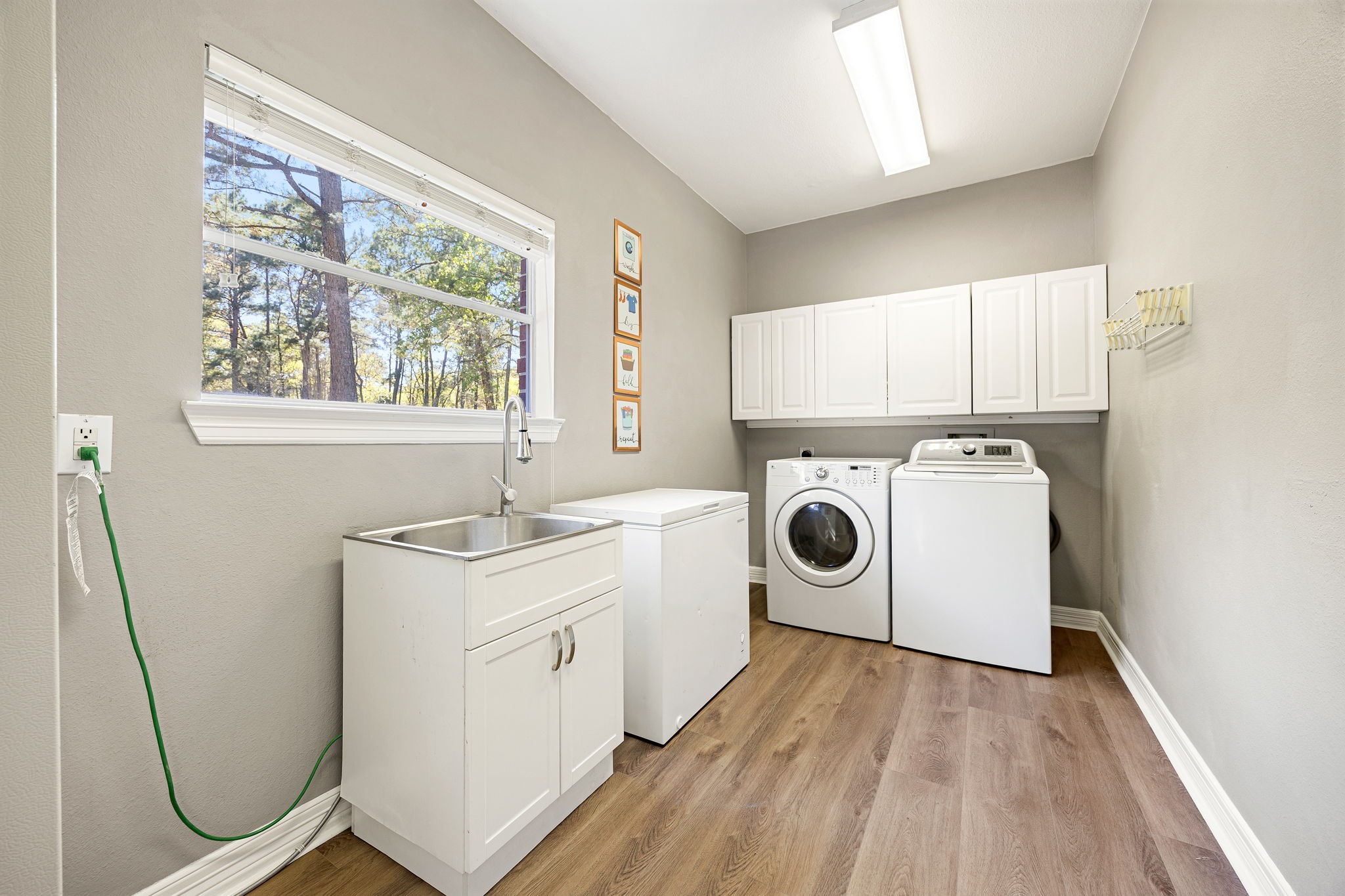 14419 Timbergreen Drive Magnolia, TX 77355 - Photo 27 of 43 Bright and spacious laundry room with sink, cabinets, and plenty of space for storage and organization.