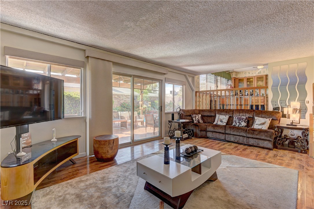 3751 El Camino Road Las Vegas, NV 89103 - Photo 14 of 27 Living room with wood finished floors and a textured ceiling