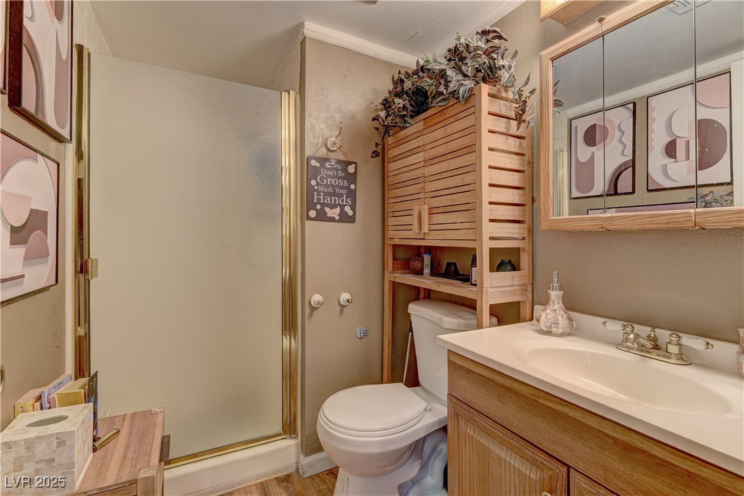 3751 El Camino Road Las Vegas, NV 89103 - Photo 17 of 27 Full bath featuring vanity, a shower stall, and ornamental molding