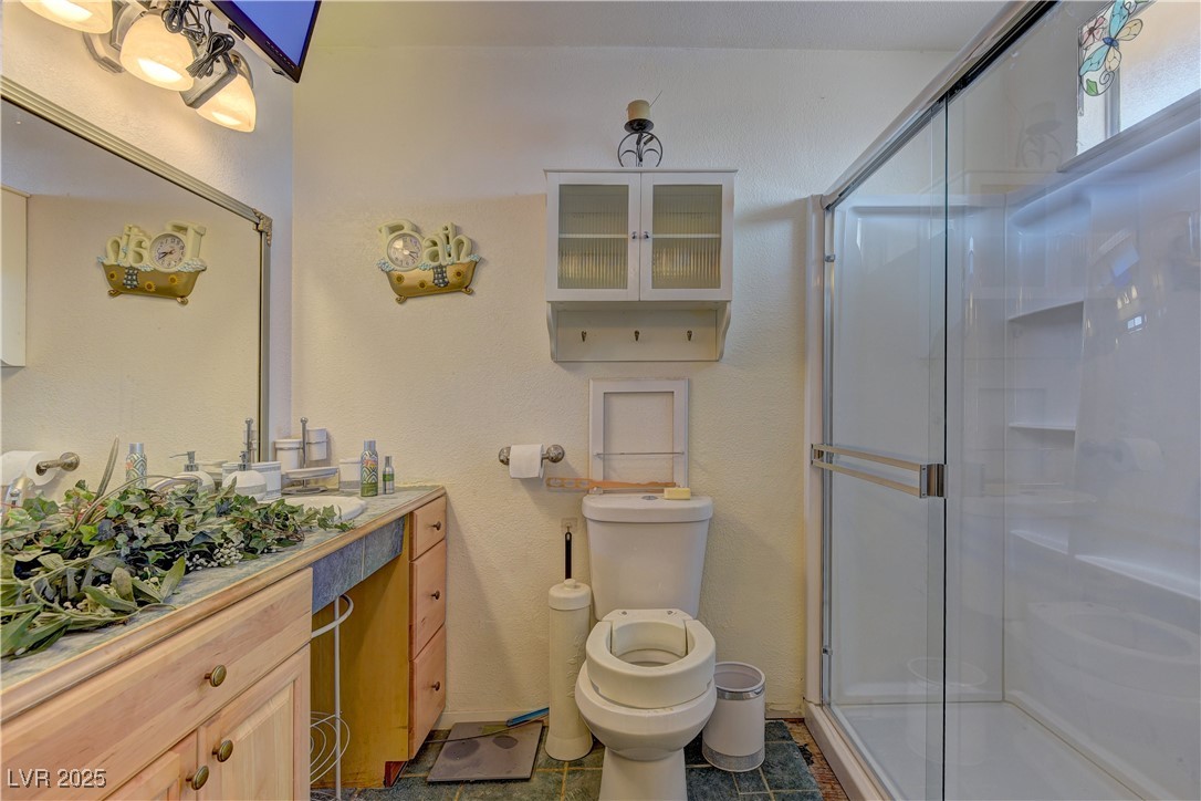 3751 El Camino Road Las Vegas, NV 89103 - Photo 19 of 27 Full bathroom with vanity, a stall shower, and tile patterned floors