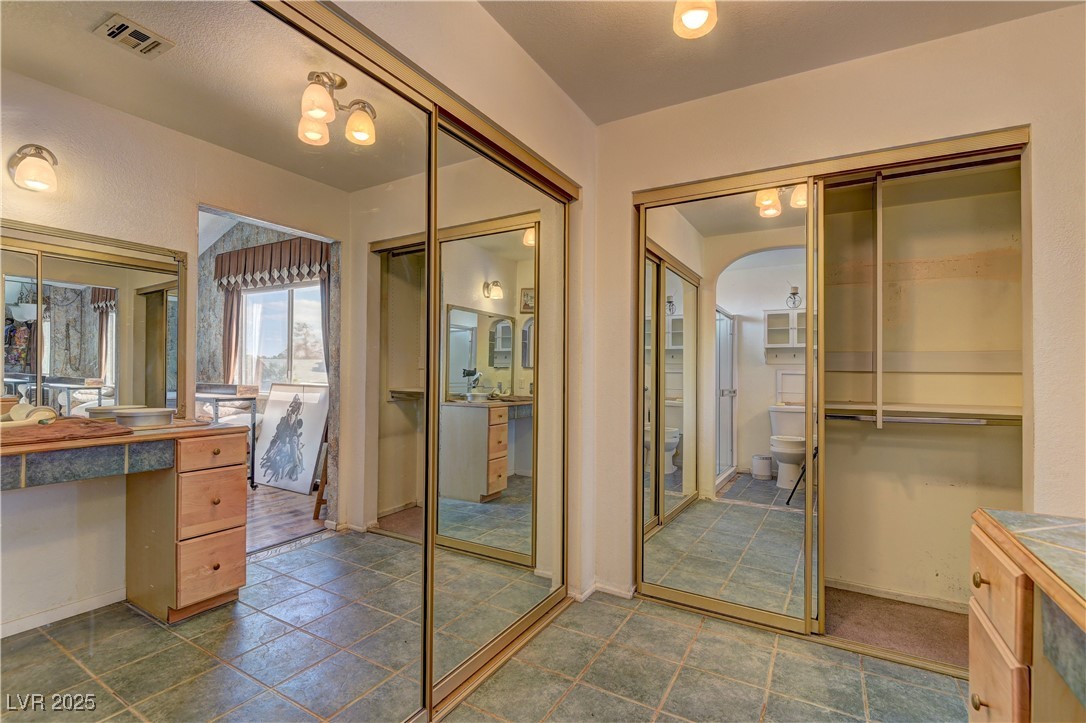 3751 El Camino Road Las Vegas, NV 89103 - Photo 20 of 27 Bathroom featuring vanity and a closet