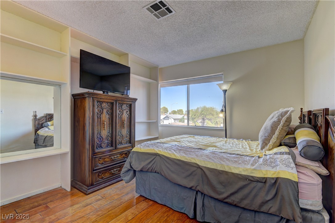 3751 El Camino Road Las Vegas, NV 89103 - Photo 21 of 27 Bedroom with a textured ceiling and hardwood / wood-style flooring