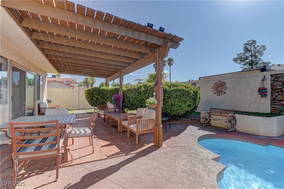 3751 El Camino Road Las Vegas, NV 89103 - Photo 24 of 27 View of pool featuring a patio, a fenced backyard, outdoor dining area, and a pergola