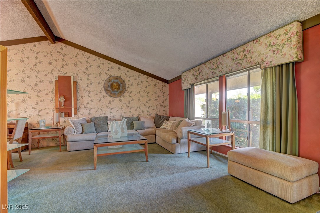 3751 El Camino Road Las Vegas, NV 89103 - Photo 8 of 27 Carpeted living room featuring wallpapered walls and a textured ceiling